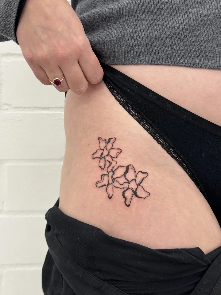 Blossom cluster sitting on the hip, just above the waistband