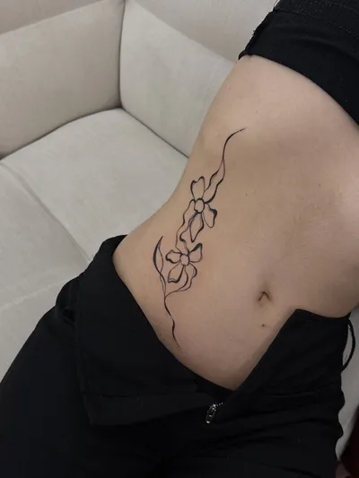 Florals and trailing whip lines curving across the hip