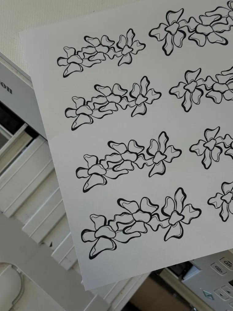 A printed sheet of hand-drawn floral designs